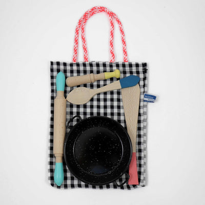 Me & Mine cooking playset with rolling pin, spatula, spoon, mortar and frying pan lying on cotton storage bag