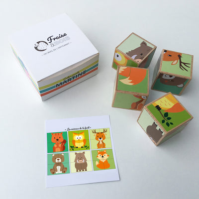 Fraise & Bois cube forest puzzle blocks sit next to the packaging box and card depicting final animal images