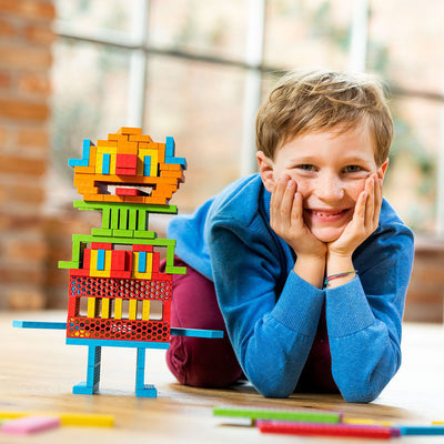 Boy next to characters made from bioblo blocks