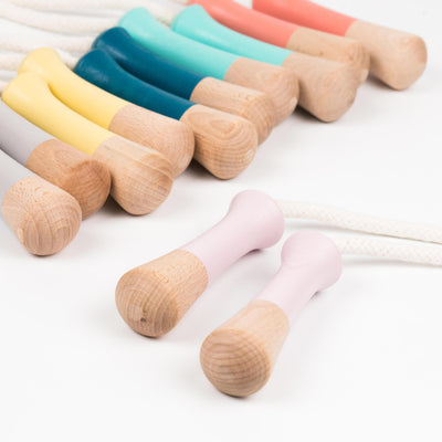 Coral, mint, blue, yellow and grey wooden Me & Mine skipping ropes with pink skipping rope in forefront