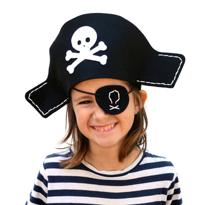 Girl smiling whilst wearing eye patch and pirate hat from aPunt Barcelona sewing kit